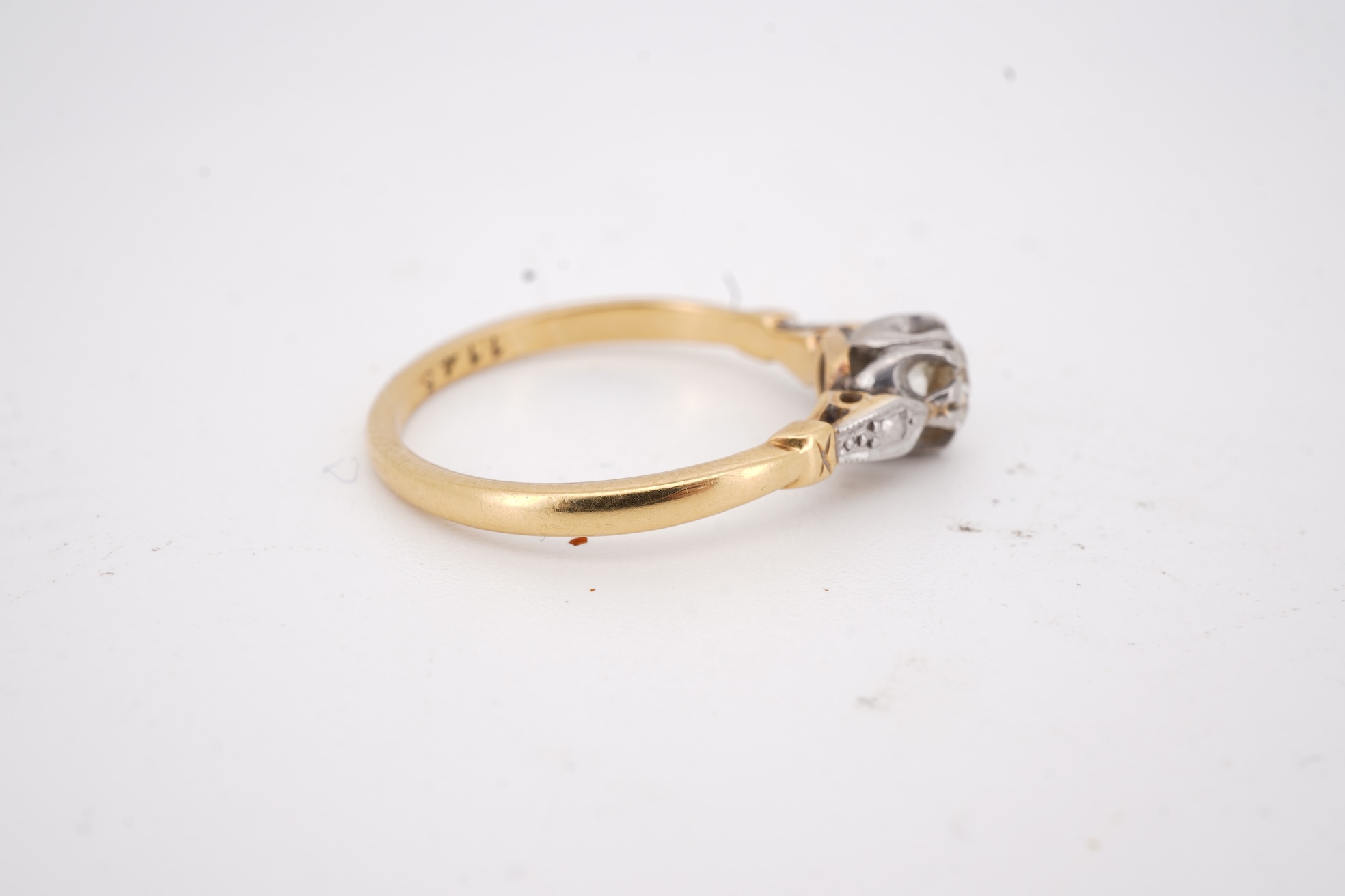 A diamond ring, set with a brilliant-cut diamond weighing approximately 0.20 carats, mounted in gold and platinum, size O1/2, stamped 18CT PLAT, gross weight approximately 2 grams, Condition: good, minor wear, diamond es
